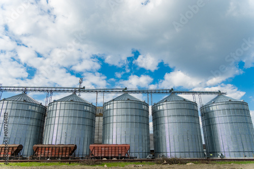 Metal tanks for storage of grain. Five large metal agricultural silos for grain storage and drying. Agricultural warehouse. Agro industry