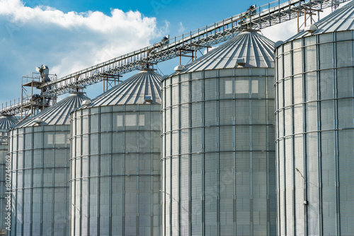 Closeup shot of metallic grain silos. Grain storage. Elevator for corn storage and grain. Agricultural warehouse. Agro industry