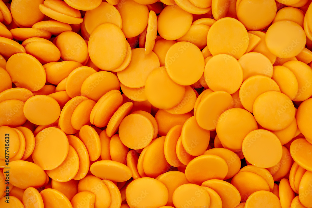 orange chocolate coating in the form of callets, chocolate drops orange chocolate coating in the form of callets, chocolate drops