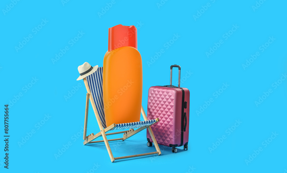 Fototapeta premium Beach deck chair and suitcase on light blue background