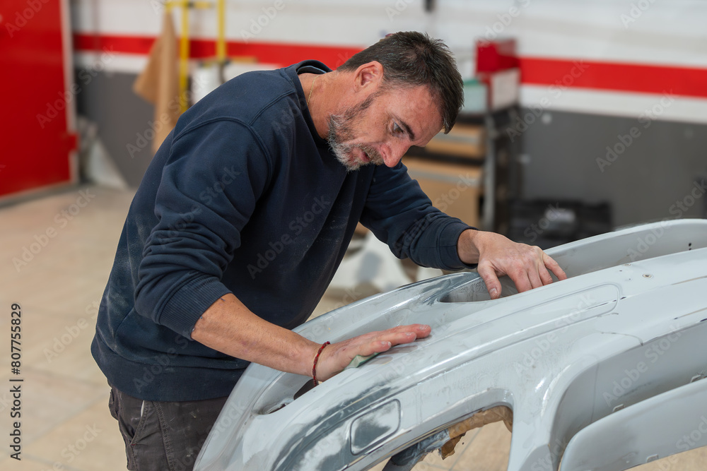 Mechanic Sanding Car Bumper for Professional Restoration Mechanic Sanding Car Bumper for Professional Restoration