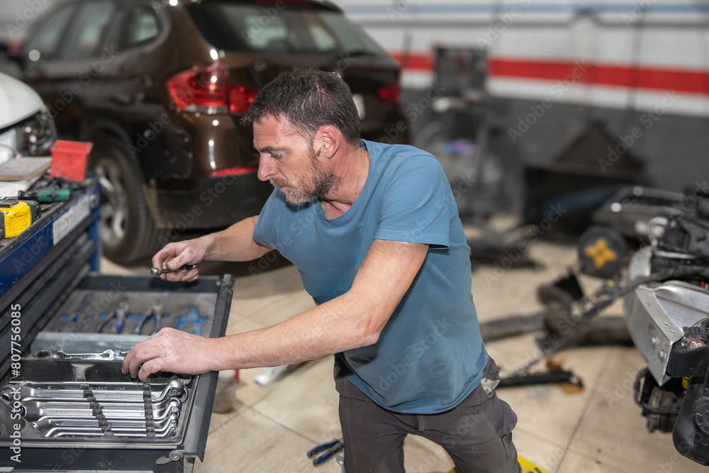 Mechanic Selecting Tools for Car Repair in Workshop Mechanic Selecting Tools for Car Repair in Workshop