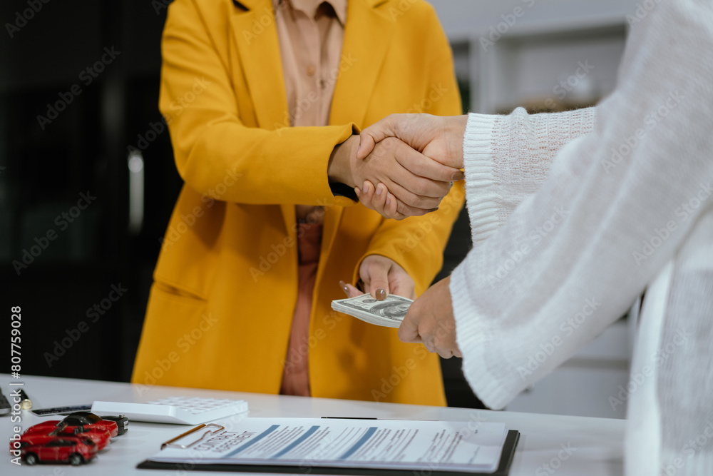 Obraz premium Car Dealership model with agent asking costumer for contract to buy, get insurance, successful deal.