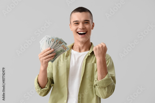 Happy young man with dollar...