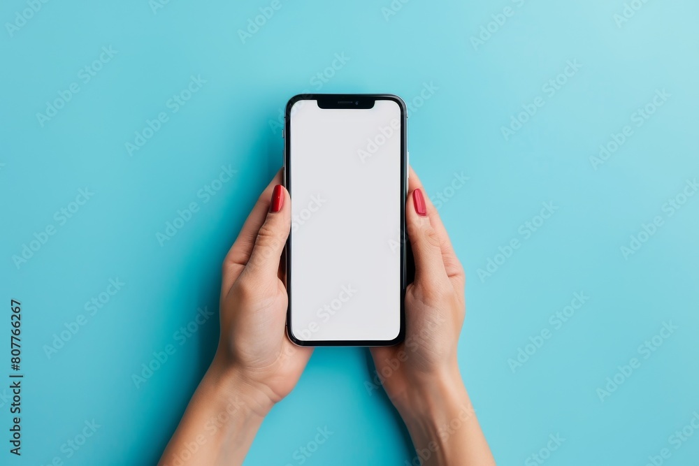 A person holding a phone with a white screen. The phone is in a hand and the person is looking at it