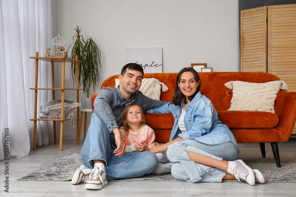 Happy family sitting in living room. New house concept Happy family sitting in living room. New house concept