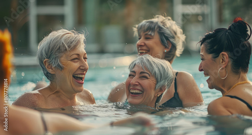 A group of happy senior women in the pool, swimming and laughing together © Kien