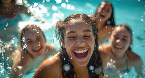 A group of happy young women in the pool, swimming and laughing together