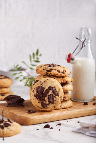 Butter cookies with chocolate chips served with glass of milk. Delicious homemade dessert.