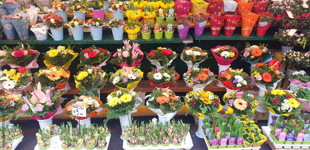 Panorama of various flowers in a boutique on a city street.