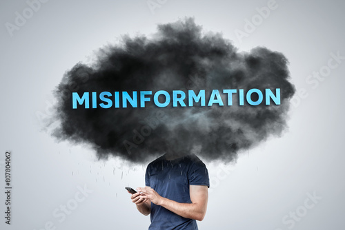 Dark Cloud Labeled 'Misinformation' Hovering Over a Person's Head photo