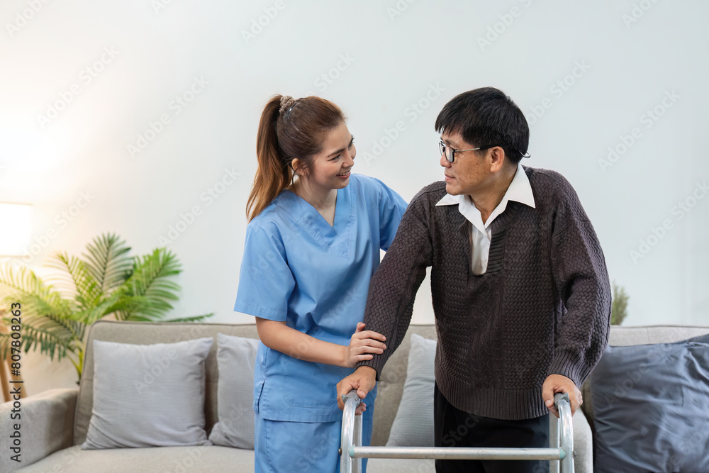 Obraz premium Nurse or caregiver help elderly walk by using walker at home. healthcare home visit concept