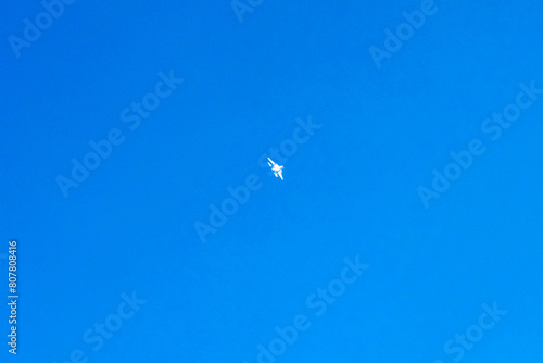 Supersonic fighter plane is flying on isolated blue sky