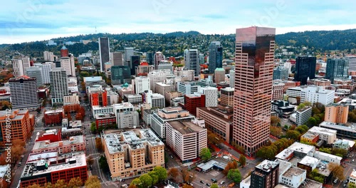 Varied architecture of Portland, Oregon, US at the waterfront of the River Willamette. Green built-up rocks at backdrop. Top view.