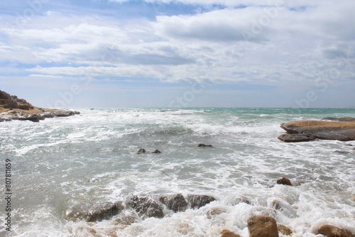 natural background of sea sky and stones, beautiful view of Mediterranean coast in Spain, waves in the sea