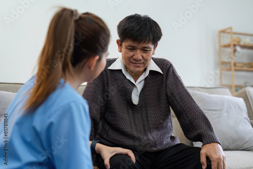 physiotherapist doctor or caregiver helping senior elderly man stretching his hamstring