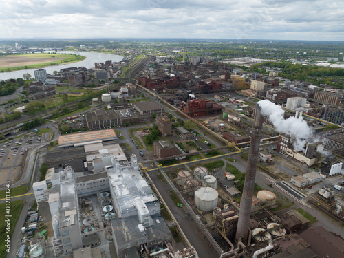 Smoking smoke stack at chemical park in the german Ruhr Area. Heavy industry, 4K Aerial drone view.