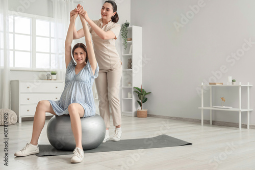 Young pregnant woman on fit...