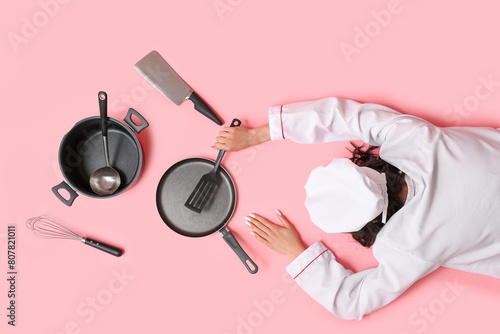 Happy young female cook wit...