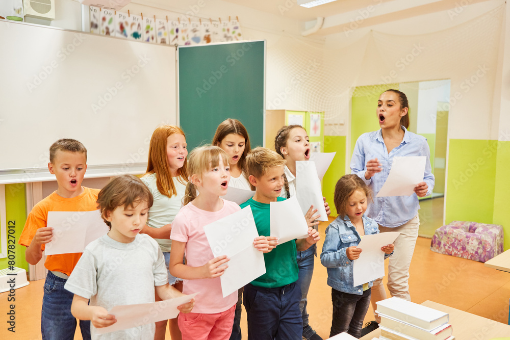 Students and teacher singing choir in class