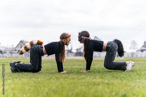 Teenage girl with cat mask and gloves doing Quadrobics. girl in a cat mask Jumps like a cat