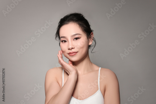 Portrait of beautiful woman on grey background