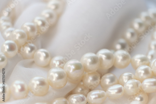 The soft focus pearls on a white canvas evoke a sense of calm and timeless beauty. This tranquil scene provides a respite from the relentless pursuit of the ultra-modern aesthetics.