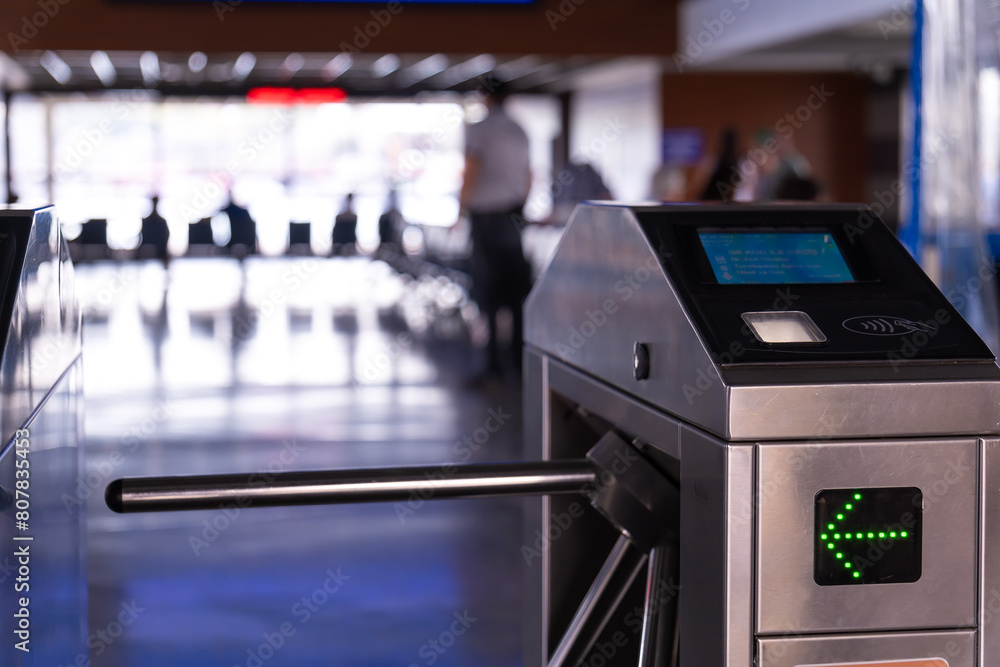 Turnstile is a close-up with a green arrow. Control and security. Pass through the passes. Turnstiles in the subway, on the piers.