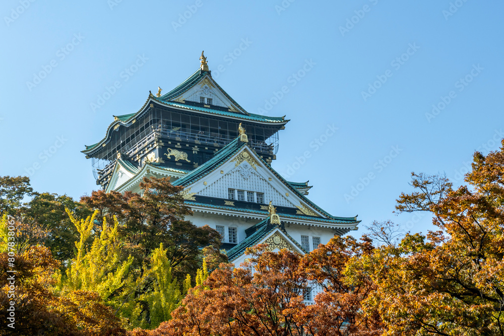 Osaka's landmark Osaka Castle castle tower that shines in the blue sky, autumn season Osaka's landmark Osaka Castle castle tower that shines in the blue sky, autumn season