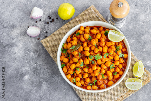 Healthy Chickpea Masala in a Bowl Top Down Photo on Dark Background