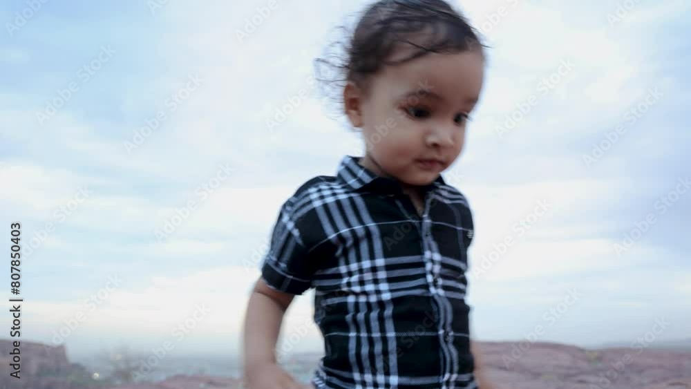 isolate infant walking at mountain rock at evening isolate infant walking at mountain rock at evening