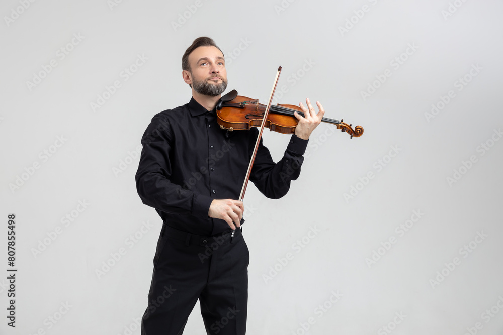 Elegant musician man violinist playing on concert Elegant musician man violinist playing on concert