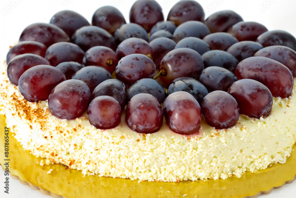 Fototapeta premium grape cake. large lush light cake with white cream and purple large grapes on top, close-up, sweet concept