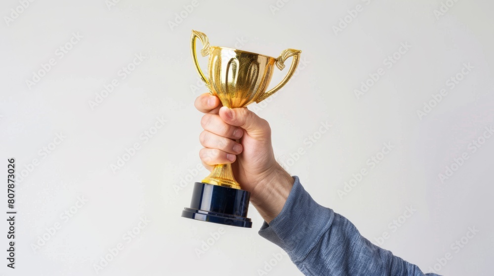 A Hand Holding a Victory Trophy