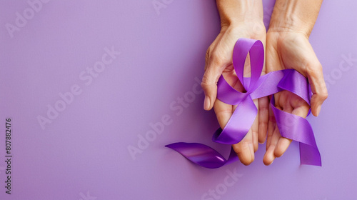 on world lupus day and world cancer day adult hands holding purple ribbon on purple background © Ja