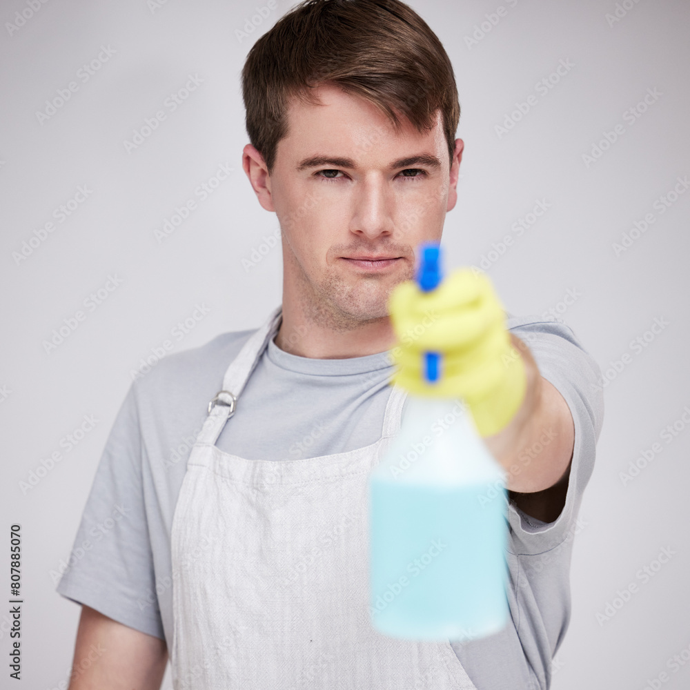 Man, portrait and studio for cleaning with spray bottle, serious and disinfectant liquid cleaner for germs maintenance. Health, safety and hygiene, glove for bacteria protection on white background Man, portrait and studio for cleaning with spray bottle, serious and disinfectant liquid cleaner for germs maintenance. Health, safety and hygiene, glove for bacteria protection on white background