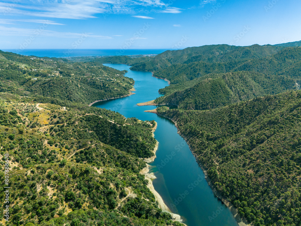 Fototapeta premium Experience the picturesque charm of Istán from a bird's-eye perspective, as the drone captures its quaint streets and stunning mountain backdrop
