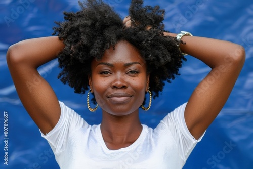 A woman with afro hair is striking a pose for a photo, showcasing her unique hairstyle photo