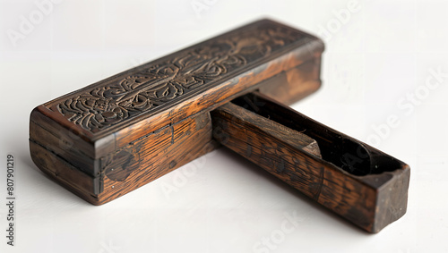 A very old, worn desk accessory made of dark wood.