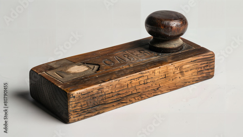 A very old, worn desk accessory made of dark wood.