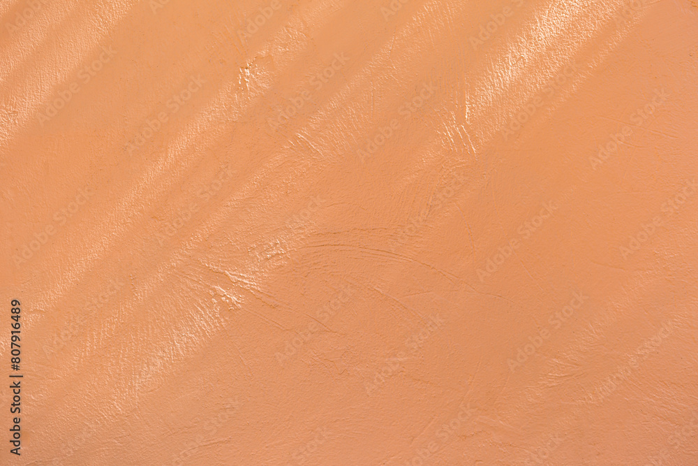 Fototapeta premium Orange cement wall under the shade background, morning light shade on blank orange wall, outdoor day light