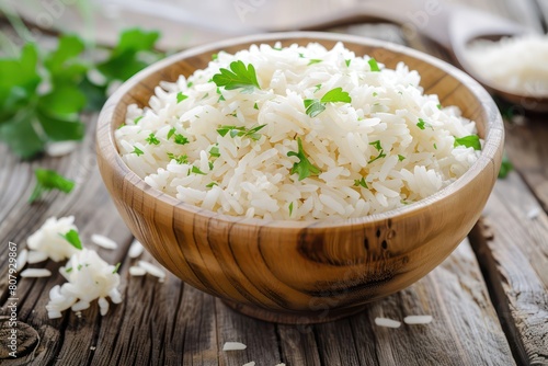 Bowl of rice with garlic and parsley on a wooden table