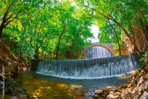 The old stone, arched bridge, between two waterfalls in Palaiokaria, Trikala prefecture, Thessaly, Greece. photo