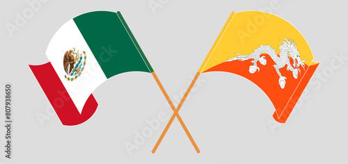 Crossed and waving flags of Mexico and Bhutan