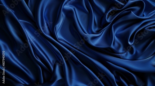 Background of blue silk fabric with luxury satin cloth wave texture. Abstract pattern of royal curtain velvet with drapery. Elegant navy color material for grand fashion event decoration