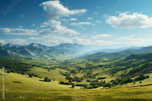 Picturesque Green Valley with Rolling Hills and Distant Mountains Under Blue Sky.