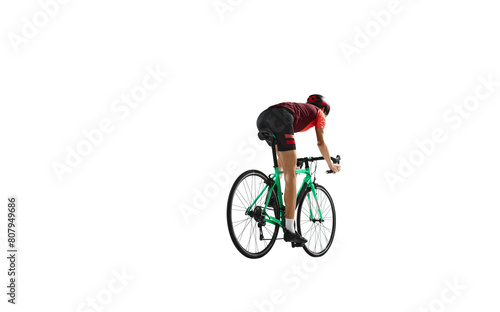 Back view. Young man, cyclist in sportswear and helmet riding bicycle, training against transparent background. Concept of sport, action, competition, power and endurance, health marathon.