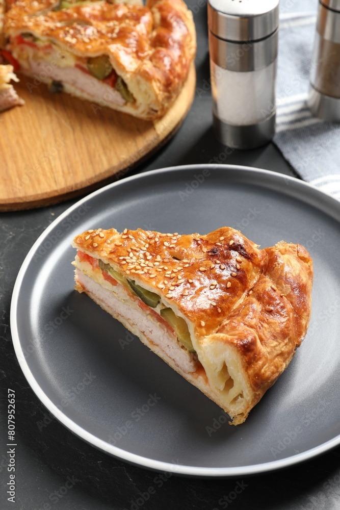 Piece of tasty homemade pie with filling on dark grey table Piece of tasty homemade pie with filling on dark grey table