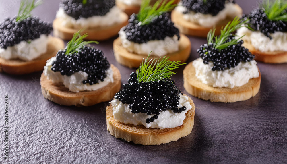 Close-up of canapes with cream cheese and black caviar. Delicious snack. Tasty delicacy. Close-up of canapes with cream cheese and black caviar. Delicious snack. Tasty delicacy.