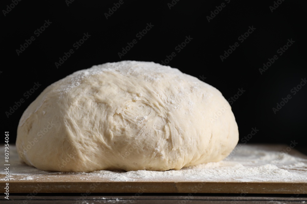 Raw homemade dough on wooden table, closeup Raw homemade dough on wooden table, closeup